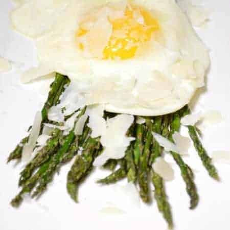 Baked asparagus topped with a sunny side up egg, and shaved parmesan cheese. This asparagus appetizer could actually be served as an appetizer, a side dish, or even as a lunch meal! Super easy to make, and DELICIOUS! This is a dish that is sure to please the whole family!