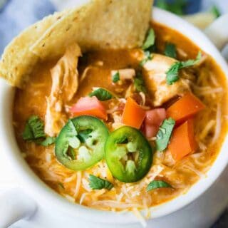 Slow Cooker King Ranch Chicken Soup. This EASY soup tastes just like the beloved King Ranch Chicken Casserole. Loaded with cheese, juicy chunks of chicken, and tons of flavor! Simply load up the slow cooker and let this soup simmer during the day so you can enjoy this for dinner!
