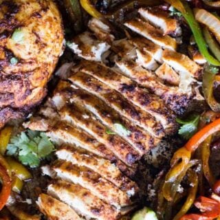 Sheet Pan Chicken Fajitas. An easy to put together dinner that is full of flavor and only uses ONE PAN! Juicy chicken seasoned with a homemade fajita seasoning is mixed with brightly colored bell peppers and onion for a classic tex mex meal. The entire family will love this one!