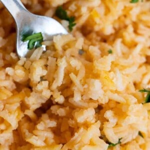 Close up view of Mexican Rice or Arroz Rojo, showing the fluffy texture and pale red color of the rice.