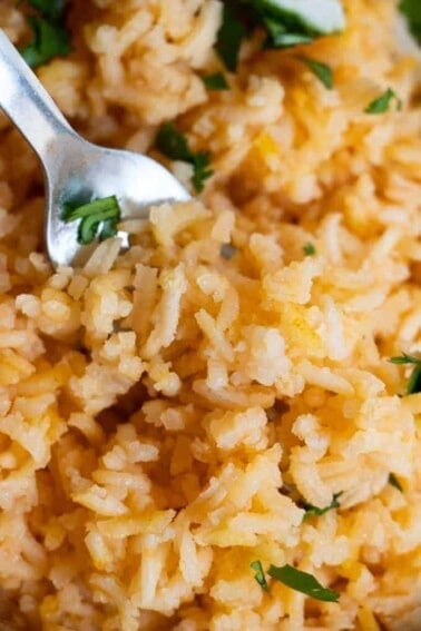 Close up view of Mexican Rice or Arroz Rojo, showing the fluffy texture and pale red color of the rice.
