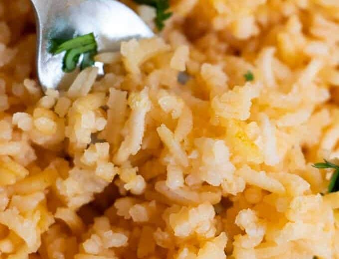 Close up view of Mexican Rice or Arroz Rojo, showing the fluffy texture and pale red color of the rice.