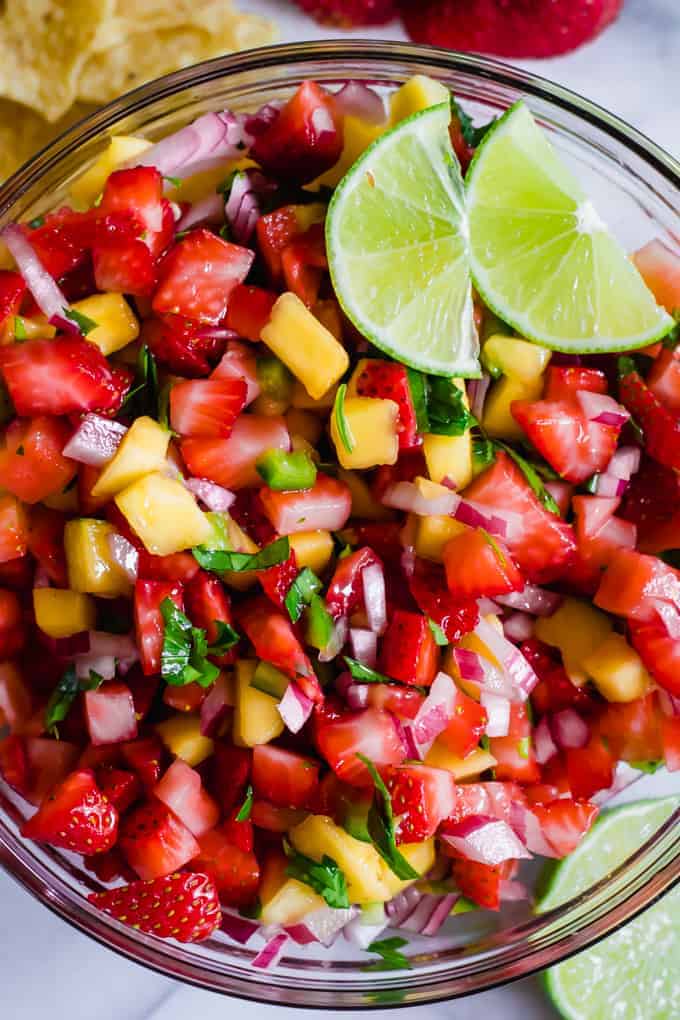 Close up of the strawberry mango salsa, showing the bits of onion and cilantro. 