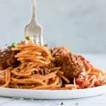 A fork with noodles twirled around.