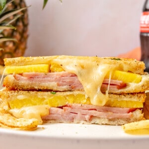 Stacked halves of a pineapple grilled cheese sandwich with melted cheese coming out.