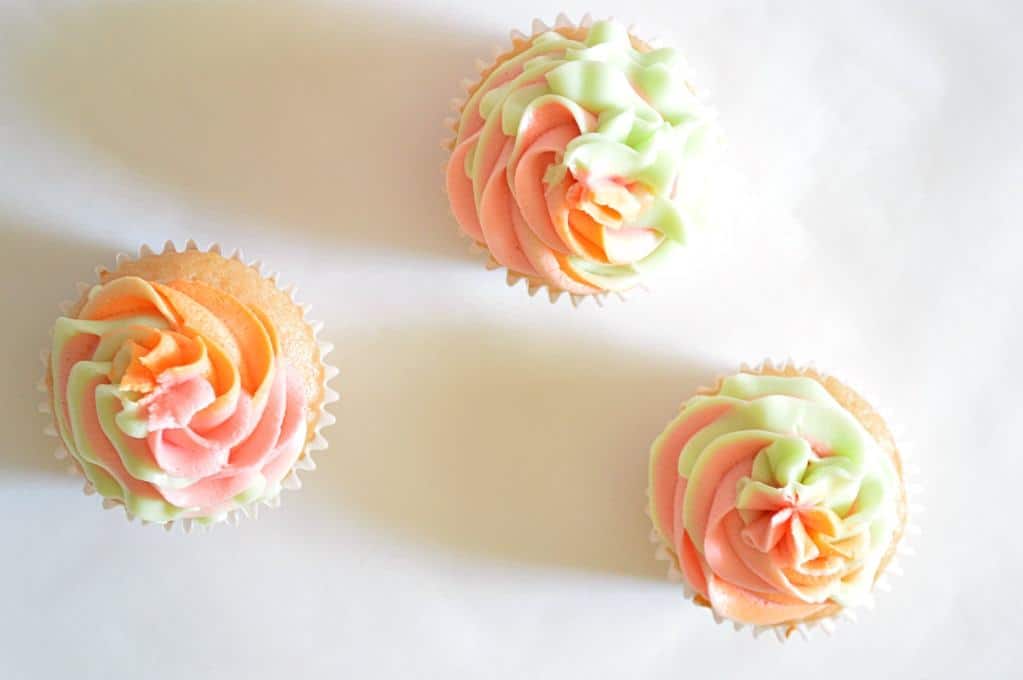 These Rainbow Sherbet Cupcakes are made with real rainbow sherbet in the cake batter and topped with three flavors of swirled frosting! #houseofyumm