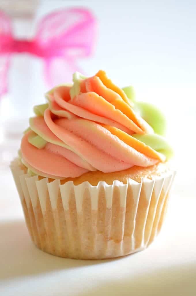 These Rainbow Sherbet Cupcakes are made with real rainbow sherbet in the cake batter and topped with three flavors of swirled frosting! #houseofyumm