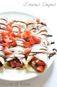 Enjoy S'mores for breakfast with this easily assembled S'mores Crepe recipe!  Crepes filled with Nutella and strawberries and topped with chocolate and marshmallow syrups.  DE-lish! 