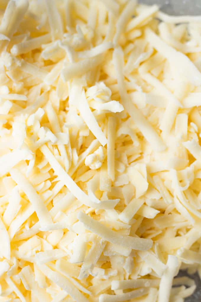 Shredded cheese ready to make homemade queso cheese dip. 