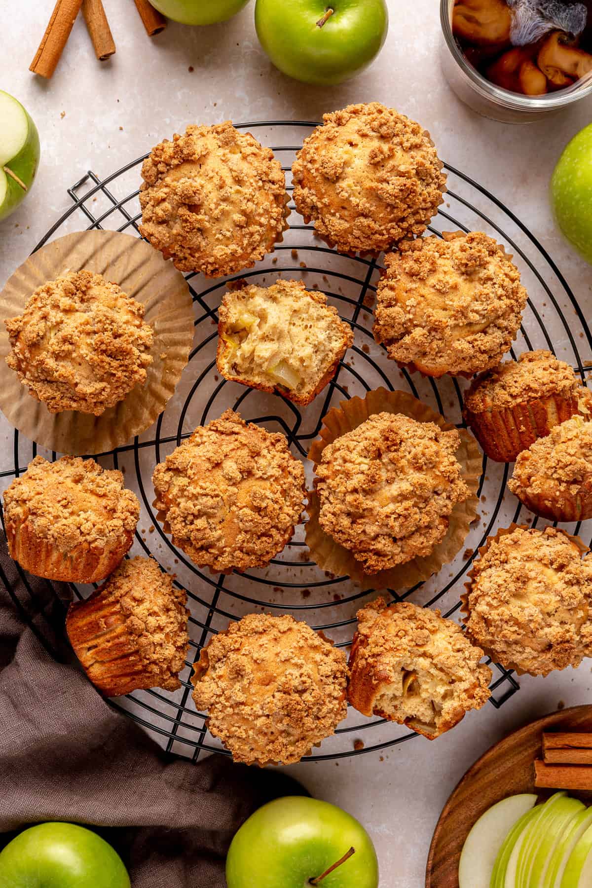 Apple muffins with a crumb topping on a wire cooling rack. 