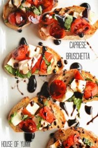 Caprese Bruschetta.  Flavorful tomatoes, basil, and fresh mozzarella with a basalmic reduction drizzle.