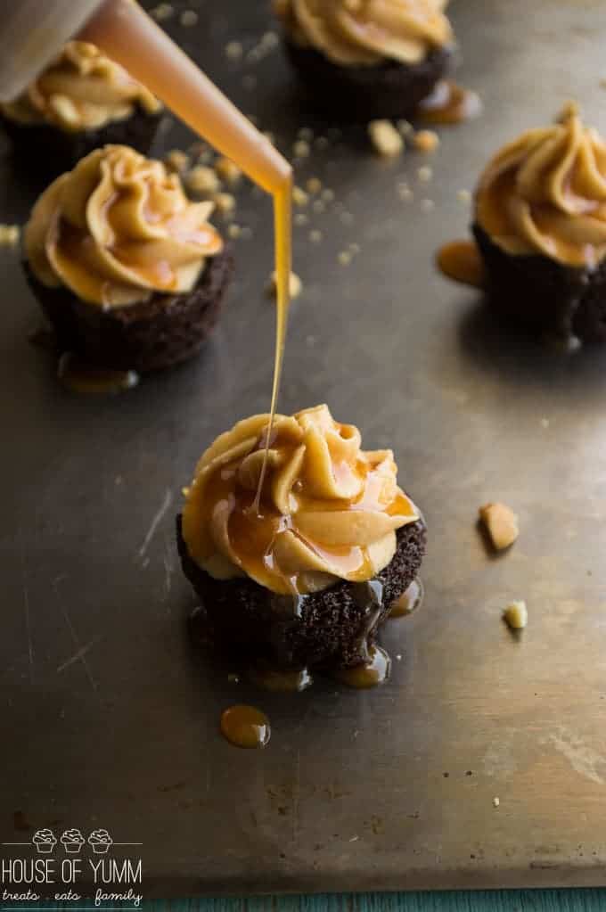 Snickers Brownie Bites. Dark Chocolate brownie bites topped with a fluffy peanut butter frosting, caramel and peanuts.