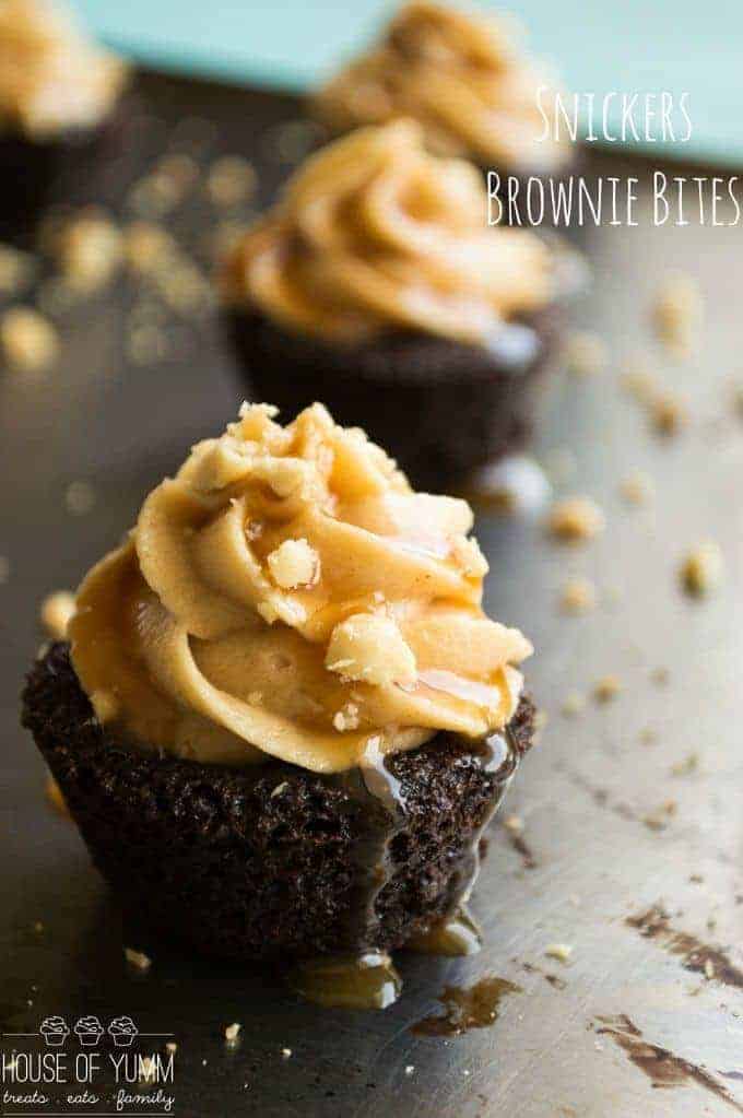 Snickers Brownie Bites. Dark Chocolate brownie bites topped with a fluffy peanut butter frosting, caramel and peanuts.