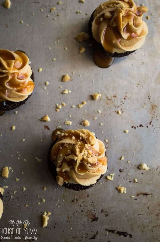 Snickers Brownie Bites. Dark Chocolate brownie bites topped with a fluffy peanut butter frosting, caramel and peanuts.