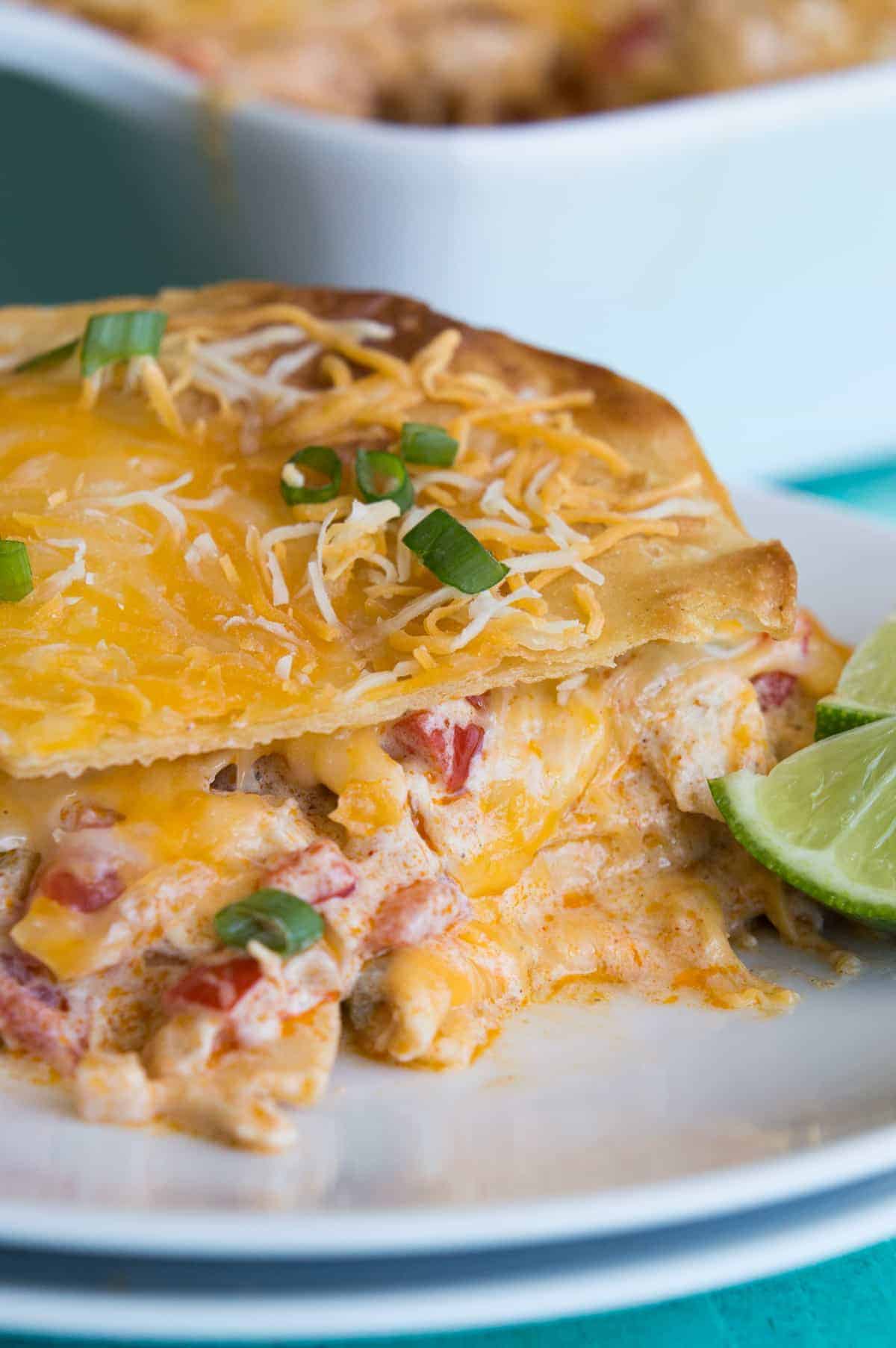 King Ranch Chicken Casserole! This cheesy casserole is basically a Texan lasagna! Layers of crispy corn tortillas, cheese, and a creamy chicken mixture loaded with bell peppers, tomatoes, green chiles, chili powder and cumin! Perfect for potlucks or family get togethers!