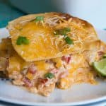 King Ranch Chicken Casserole! This cheesy casserole is basically a Texan lasagna! Layers of crispy corn tortillas, cheese, and a creamy chicken mixture loaded with bell peppers, tomatoes, green chiles, chili powder and cumin! Perfect for potlucks or family get togethers!