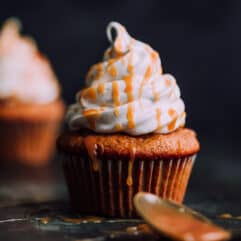 Pumpkin Cupcakes with Marshmallow Frosting by a Beautiful Plate