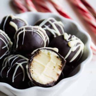 EASY 4 Ingredient Peppermint Truffles. Amazingly creamy peppermint white chocolate ganache center coated with MORE chocolate and drizzled with extra white chocolate. Perfect Christmas dessert!