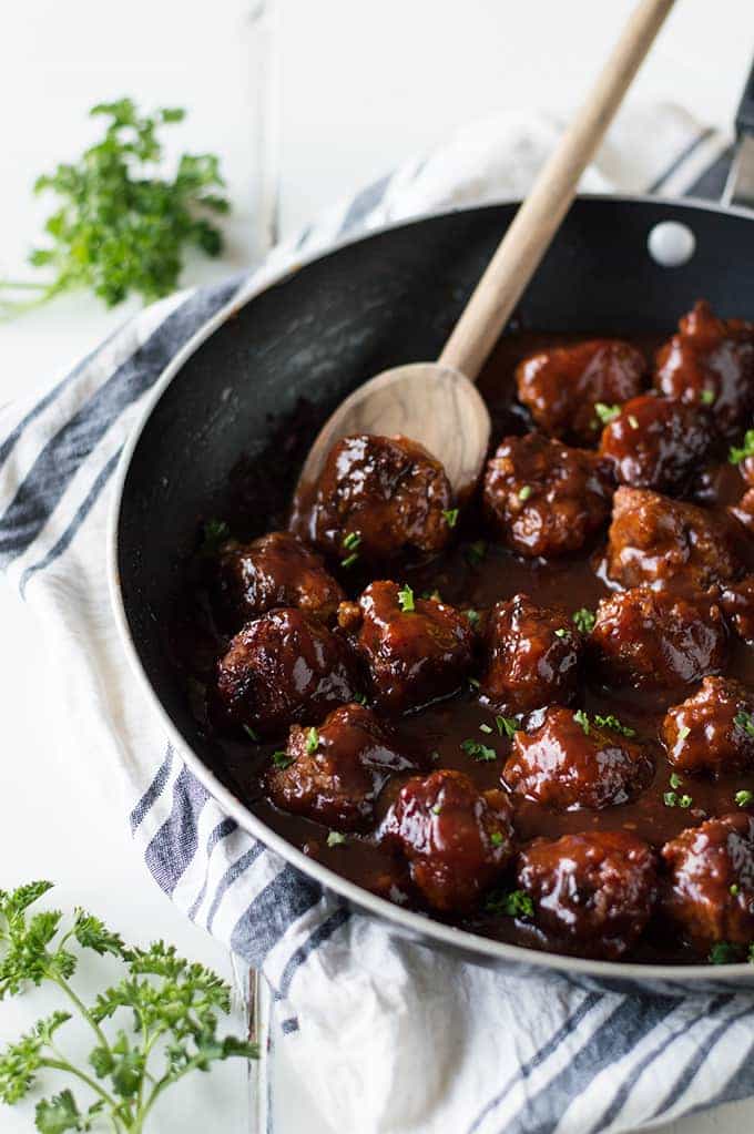 Bacon Bourbon Meatballs! These meatballs are made with bacon and ground beef and simmered in a bourbon bbq sauce. Perfect to serve as an appetizer for the big game or on a sandwich for family dinner!