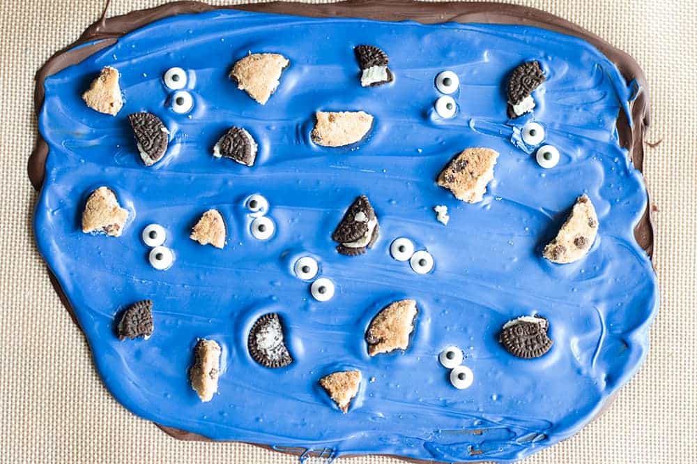 A super fun treat for all ages! Cookie Monster Bark! This easy to make bark is loaded with chunks of cookies and fun little candy eyes.