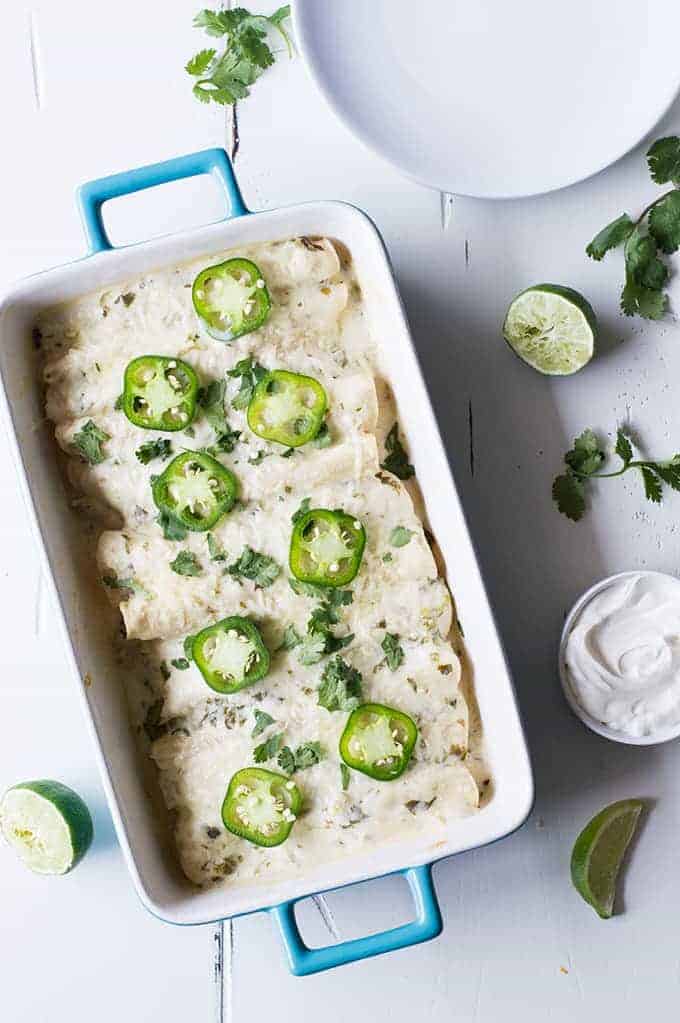 Tequila Lime Chicken Enchiladas with a Creamy Jalapeño Cilantro Sauce. These enchiladas are SO flavorful! Full of tender tequila lime chicken, cheese, and topped with a cheesy, creamy jalapeño cilantro sauce. 