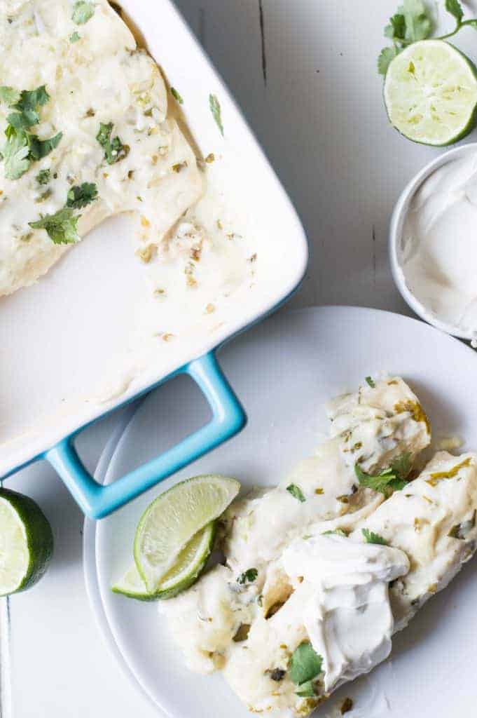 Tequila Lime Chicken Enchiladas with a Creamy Jalapeño Cilantro Sauce. These enchiladas are SO flavorful! Full of tender tequila lime chicken, cheese, and topped with a cheesy, creamy jalapeño cilantro sauce. 