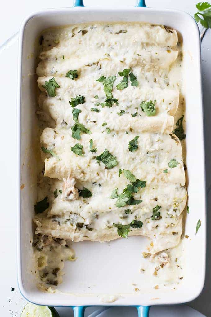 Tequila Lime Chicken Enchiladas with a Creamy Jalapeño Cilantro Sauce. These enchiladas are SO flavorful! Full of tender tequila lime chicken, cheese, and topped with a cheesy, creamy jalapeño cilantro sauce. 