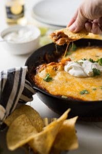 A warm tex mex enchilada dip loaded with ground beef, tons of melty gooey cheese and of course the tex mex chili gravy enchilada sauce. Enjoy the flavors of Texas with this savory snack!