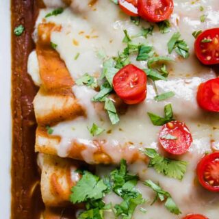 Cheese enchiladas baked with homemade enchilada sauce, topped with melted cheese.