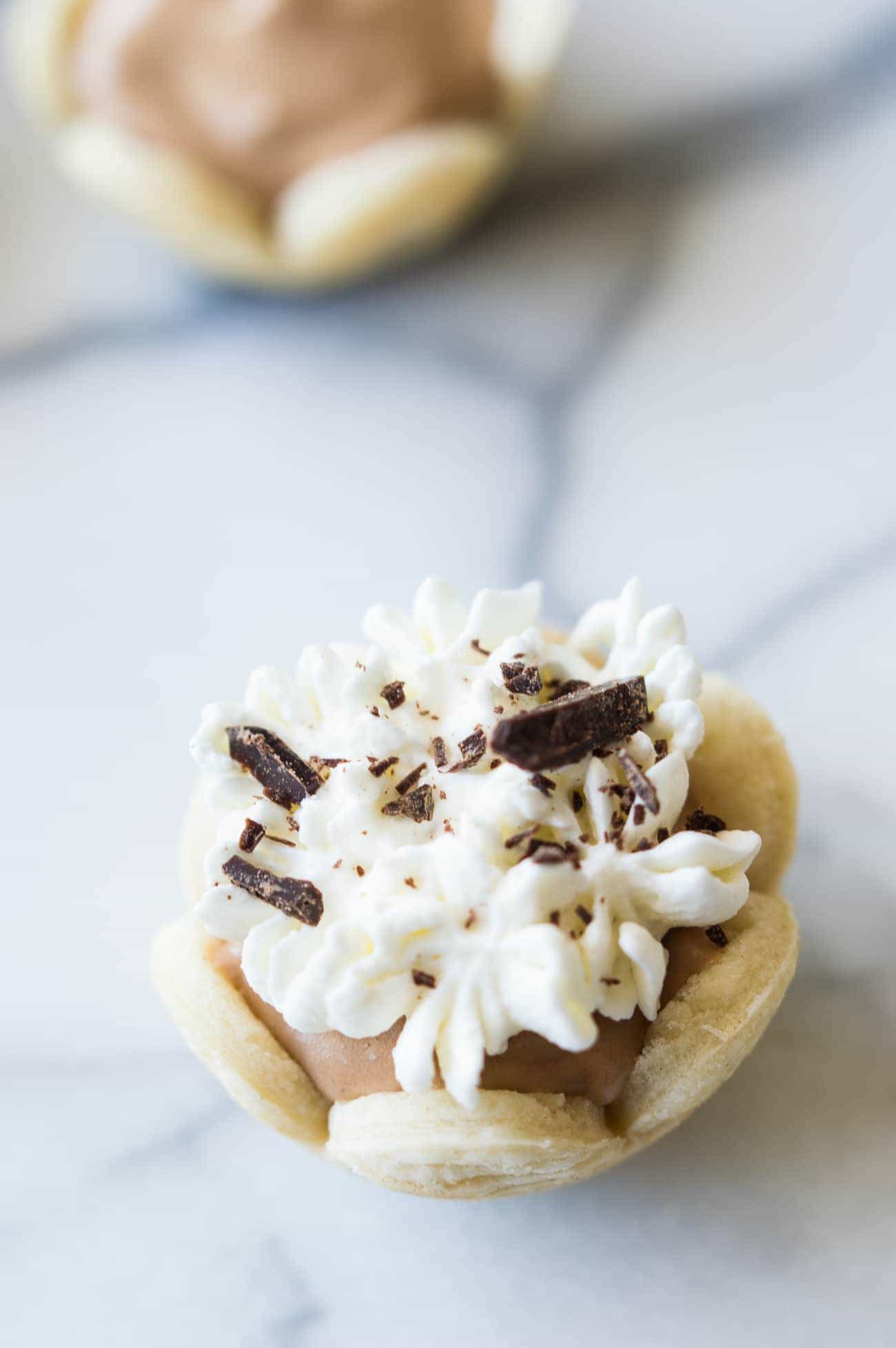 Mini French Silk Pies. Easy to make than you probably think and decadently DELICIOUS! Silky, creamy, chocolate bliss topped with homemade whipped cream. All in bite size mini pies!