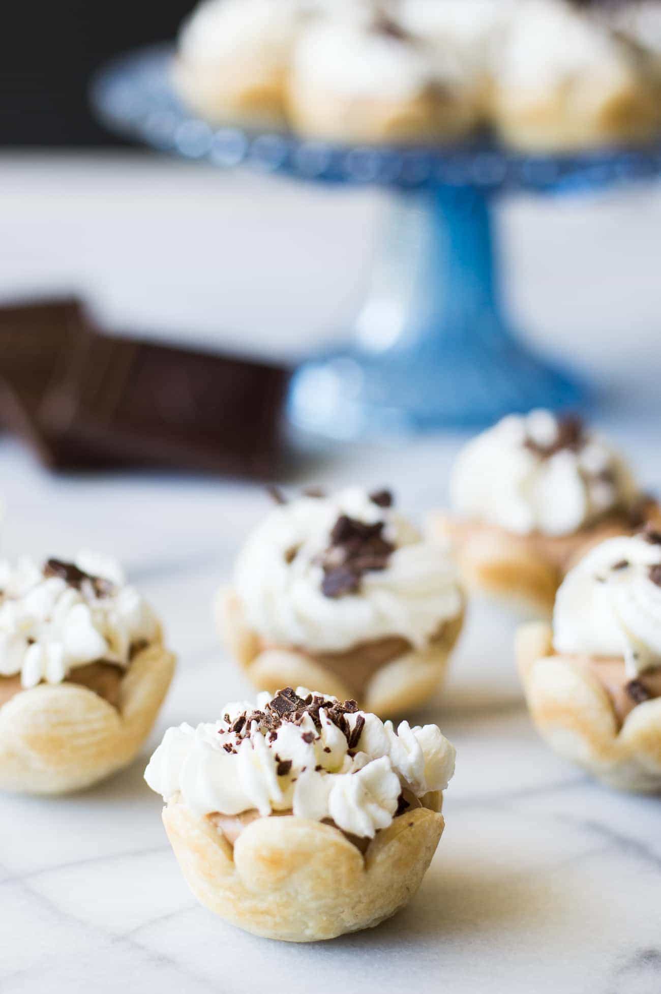 Mini French Silk Pies. Easy to make than you probably think and decadently DELICIOUS! Silky, creamy, chocolate bliss topped with homemade whipped cream. All in bite size mini pies!