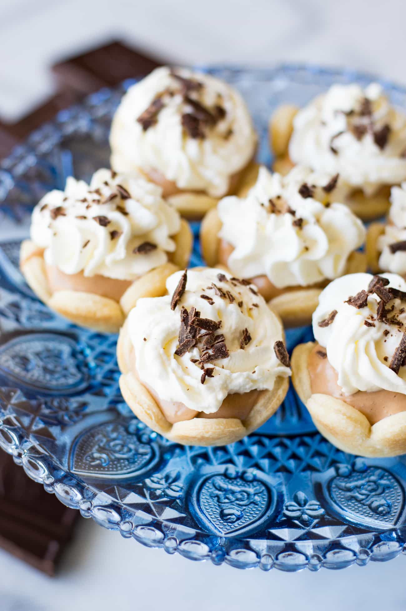 Mini French Silk Pies. Easy to make than you probably think and decadently DELICIOUS! Silky, creamy, chocolate bliss topped with homemade whipped cream. All in bite size mini pies!