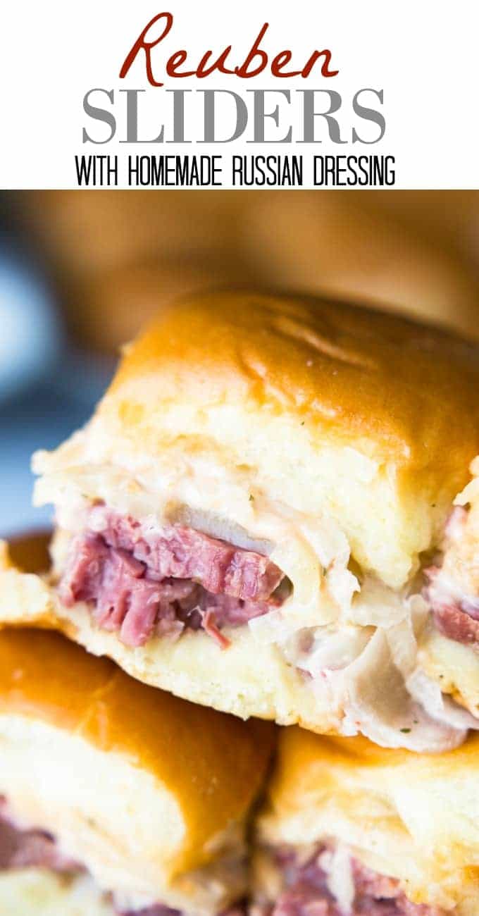 Easy to make slow cooker corned beef is layered on these sliders. Topped with Swiss cheese and a homemade Russian Dressing that makes these the BEST tasting Reuben Sliders around!!