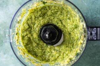Blended avocado salsa in food processor.