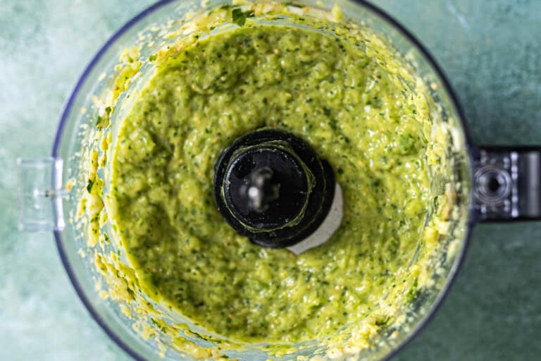 Blended avocado salsa in food processor.