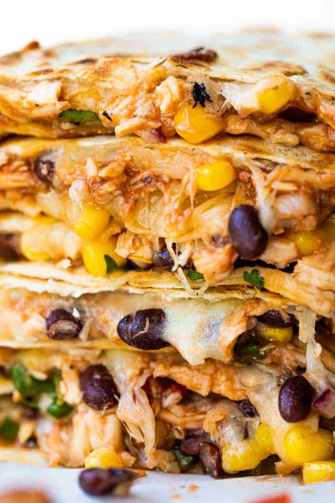 Stacked BBQ Chicken quesadillas with a Texas caviar and melted cheese. 