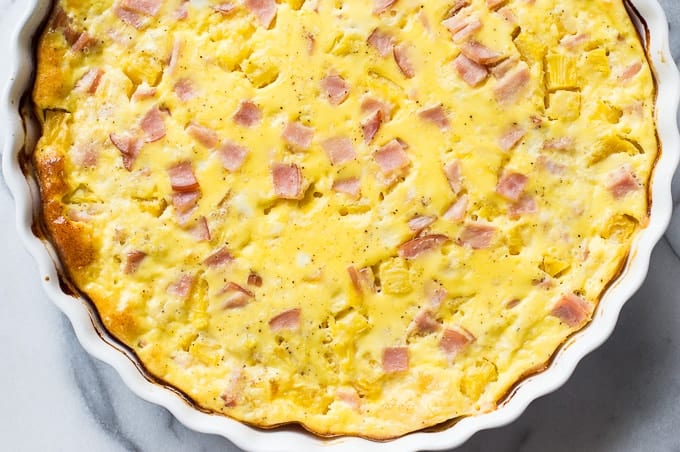 This quiche is bursting with chunks of crispy canadian bacon and juicy bits of sweet pineapple. A fun, easy, and tropical take on a breakfast classic recipe! 