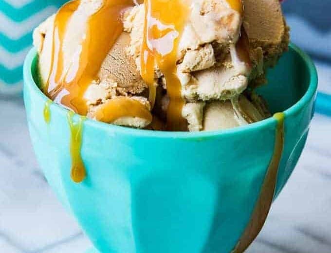 Ice cream bowl filled with homemade dulce de leche ice cream and topped with drizzles of caramel.