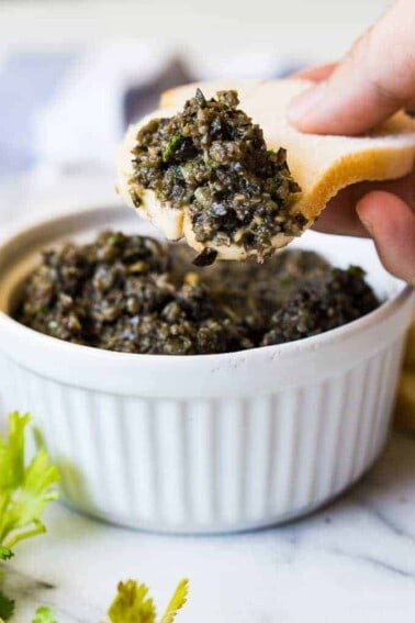 Spicy Black Olive Tapenade is the perfect appetizer made with pureed black olives, cilantro, lime juice, and jalapeños for a little bit of heat!