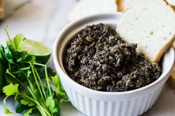 Spicy Black Olive Tapenade is the perfect appetizer made with pureed black olives, cilantro, lime juice, and jalapeños for a little bit of heat! 