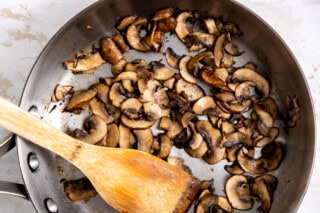 Sautéing mushrooms in a skillet.