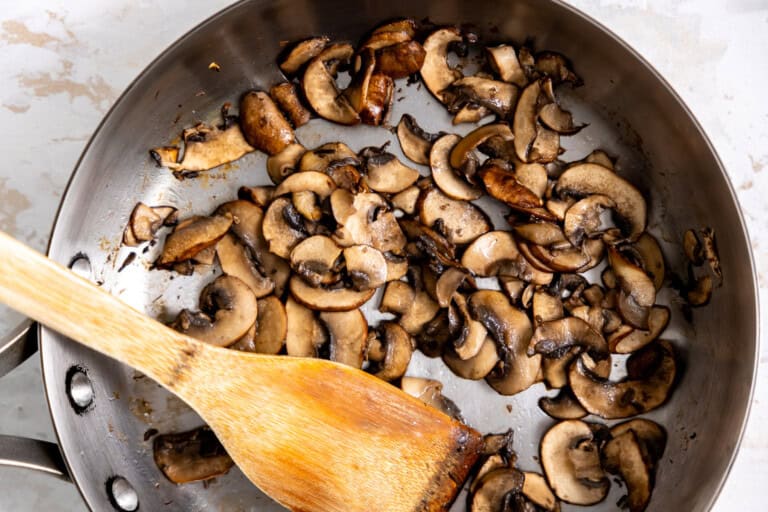 Sautéing mushrooms in a skillet.