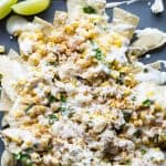 Mexican Street Corn Nachos! Chips loaded up with all the flavors of a classic mexican street corn and smothered with a creamy, spicy queso blanco.