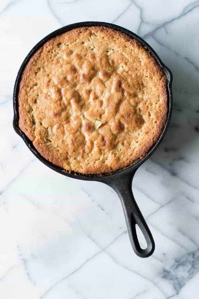 Caramel Apple Skillet cake is bursting with chunks of apple, drizzled with a homemade caramel glaze, and is perfect for Fall baking! 