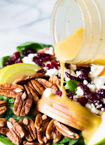 Autumn Apple Salad with a Maple Vinaigrette will let you celebrate all the flavors of Fall! Pecans, cranberries, apples, feta and baby spinach all drizzled with an easy to make maple dijon vinaigrette!