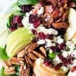 Autumn Apple Salad with a Maple Vinaigrette will let you celebrate all the flavors of Fall! Pecans, cranberries, apples, feta and baby spinach all drizzled with an easy to make maple dijon vinaigrette!