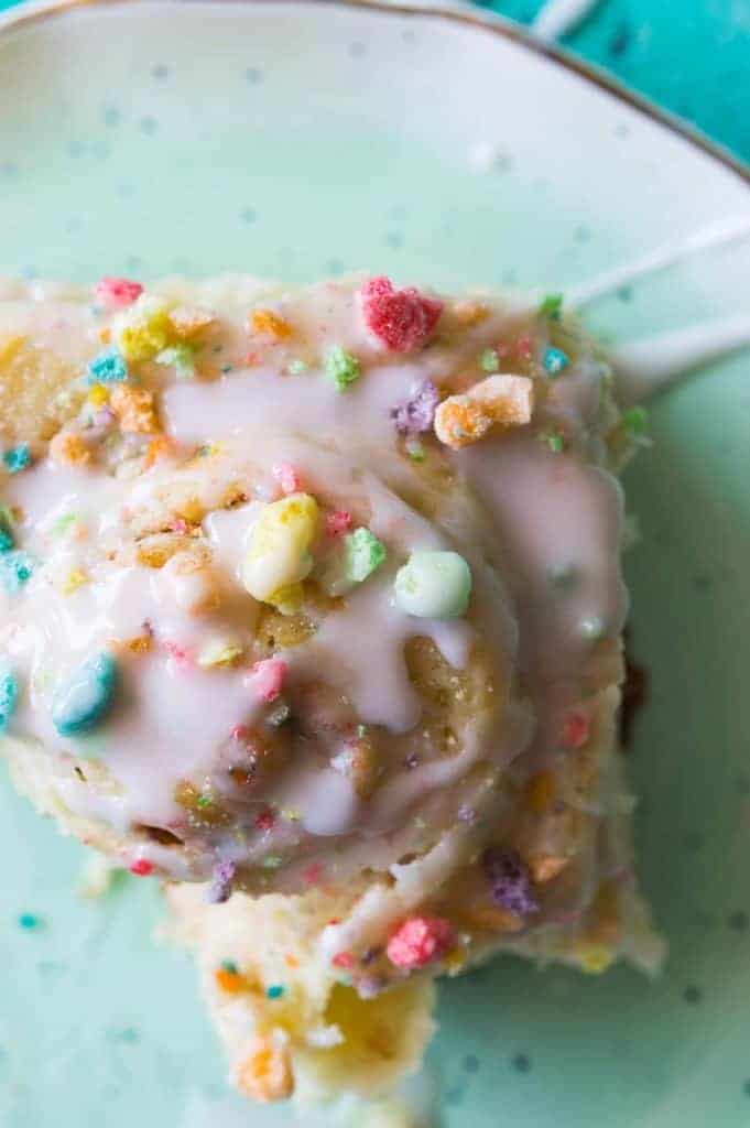 Overnight Fruit Loop Sweet Rolls made with cereal milk! Get a head start on breakfast by prepping these Fruit Loop sweet rolls the night before! Made with actual fruity cereal milk, loaded with pieces of fruit loops, and all drizzled with a fruity cereal milk glaze. These will always win the prize for the most fun breakfast!