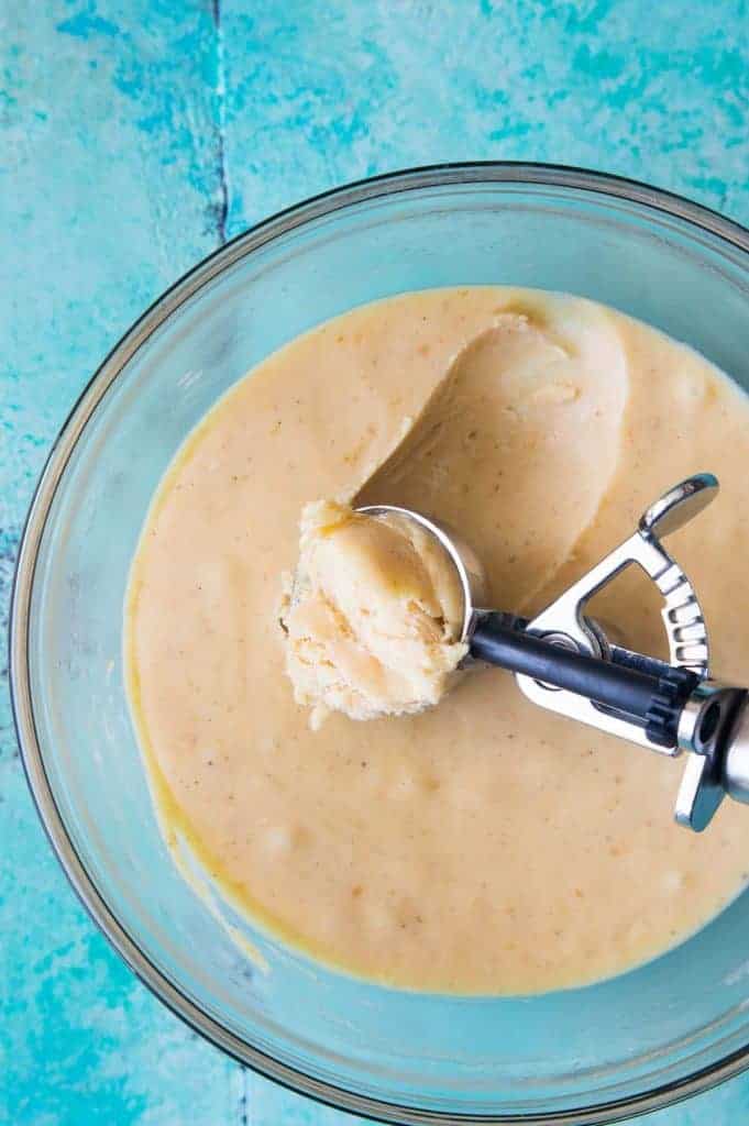 A spoon scooping hardened ganache mixture for pumpkin spice truffles. 