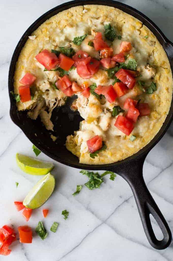 This green chile chicken tamale pie is a quick and easy dinner idea! Flavorful chicken with cheese and green chiles with a cornbread 'crust'. Prepare the chicken ahead of time to make it even quicker! Perfect for a weeknight meal. 