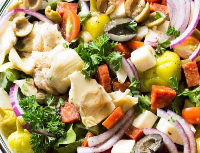 Antipasto Salad! The perfect side dish to go along with your Italian meals, loaded with artichoke hearts, roasted red peppers, olives, pepperoni, and fresh mozzarella! Not to mention drizzled with an easy to make vinaigrette made with pantry items!